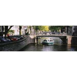 Tourboat under a Bridge in a Channel, Amsterdam, Netherlands Premium 