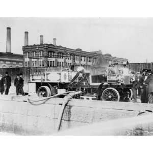 c1911 photo Fire engine with initials FDNY, being filled with water 