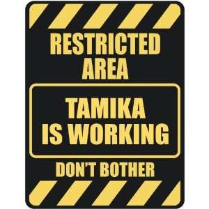   RESTRICTED AREA TAMIKA IS WORKING  PARKING SIGN
