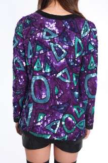   made of dazzling sequins. Snap buttons on side of neck. Fully lined