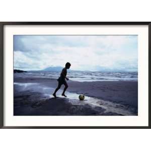 Boy Kicking Soccer Ball on Beach, Lake Nicaragua, Granada, Nicaragua 