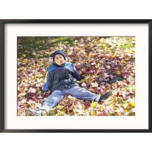  Little Boy Sitting in Leaves with Rake Collections Framed 