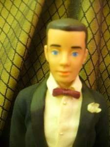 Ken is in his tux. His right side say 1960 by Mattel Inc. Hawthorne 