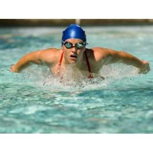  Young Woman Swimming the Butterfly Stroke in a Swimming 